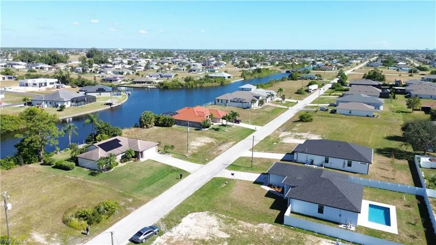 Aerial perspective of suburban area with a nearby body of water