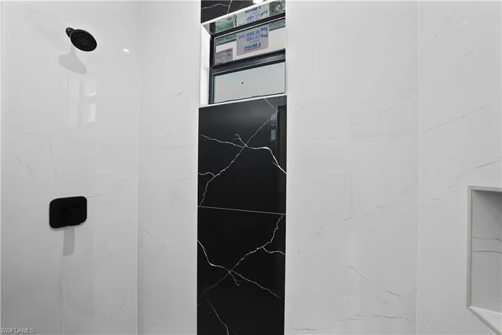 Bathroom view of a marble finish shower