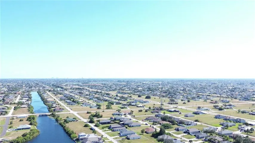 Aerial view of residential area featuring a nearby body of water and a notable bridge