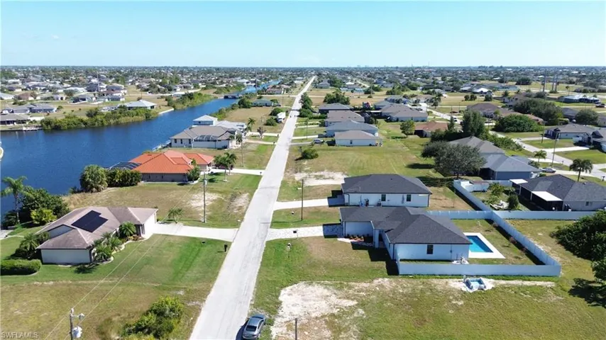 Aerial perspective of suburban area featuring a nearby body of water
