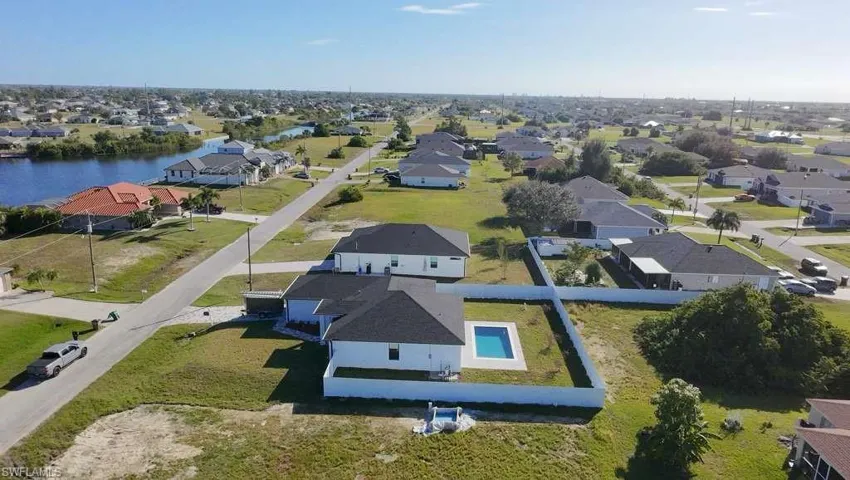 Aerial perspective of suburban area featuring a pool
