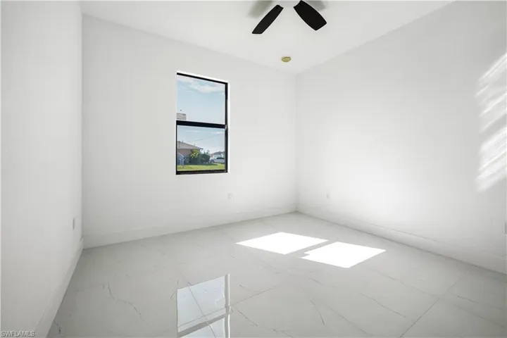 Spare room featuring baseboards and ceiling fan