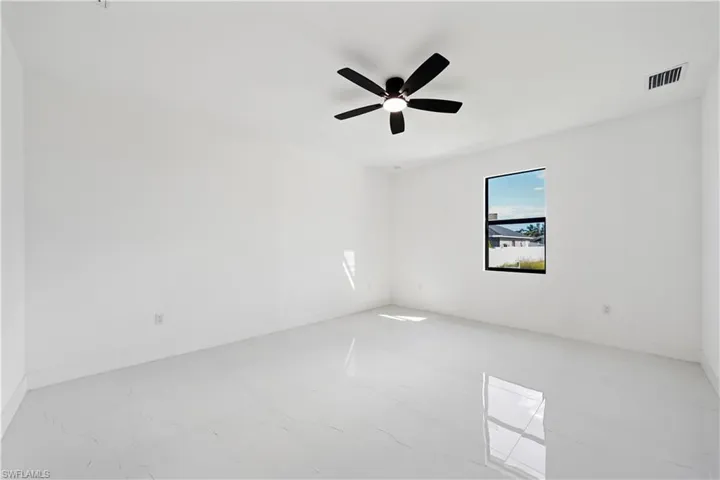 Empty room with a ceiling fan and baseboards