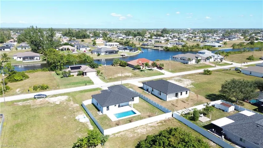 Aerial perspective of suburban area with a nearby body of water