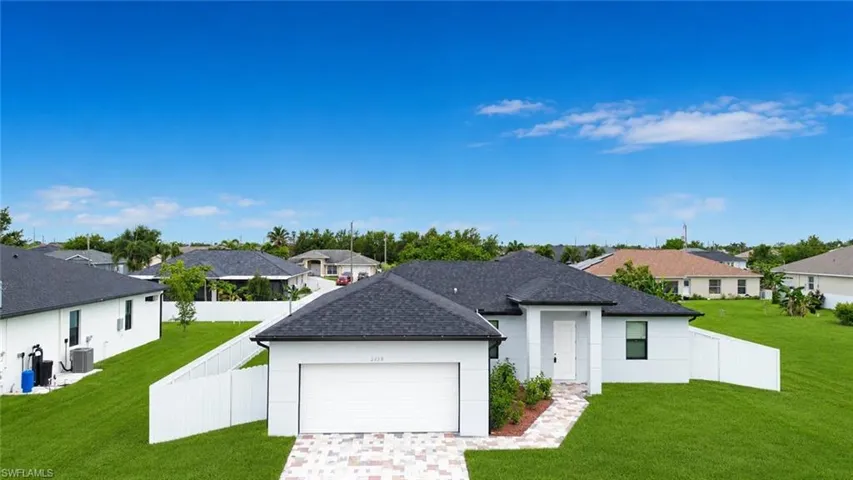 Contemporary single-story residence featuring a dark shingle roof and white exterior siding