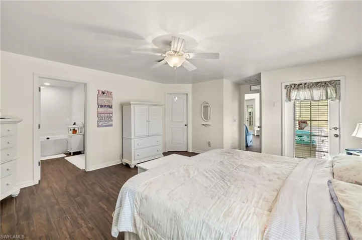 Bedroom with ceiling fan, baseboards, dark wood finished floors, and access to outside
