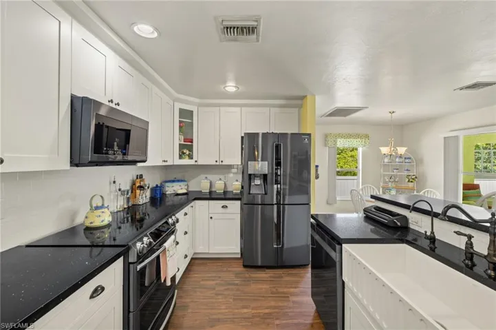Kitchen with visible vents, a healthy amount of sunlight, stainless steel appliances, and a sink