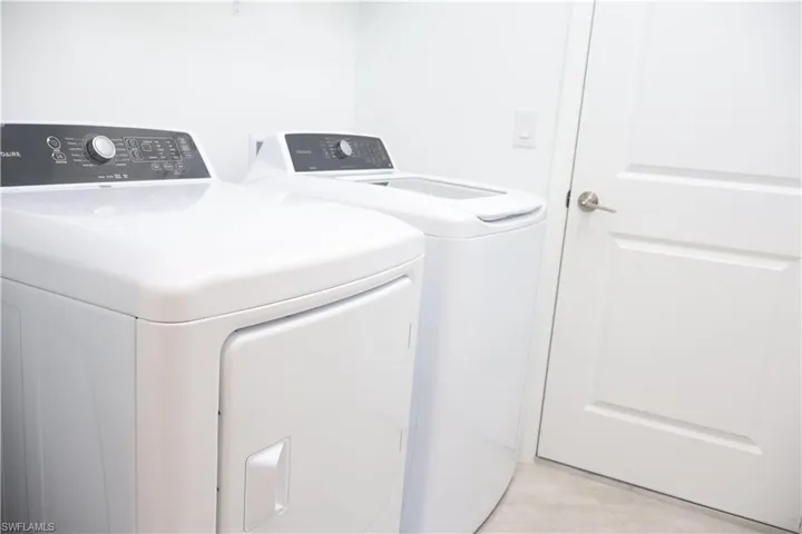 Laundry room featuring washing machine and clothes dryer
