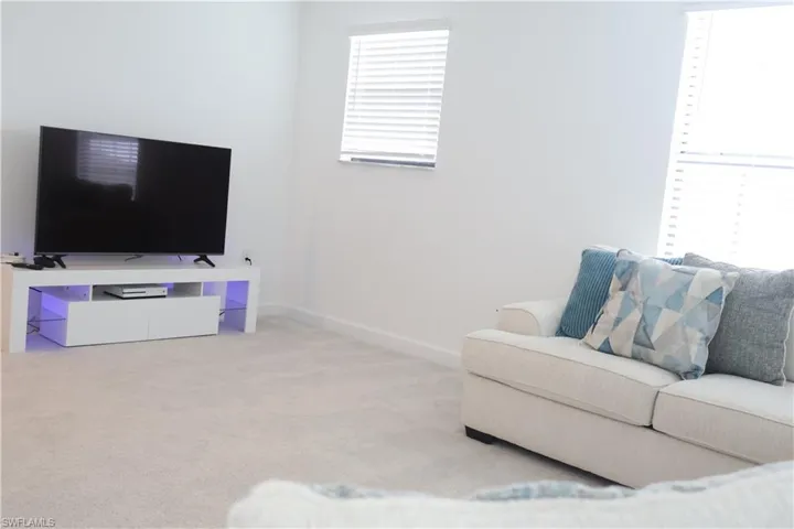 Living room with carpet flooring and baseboards