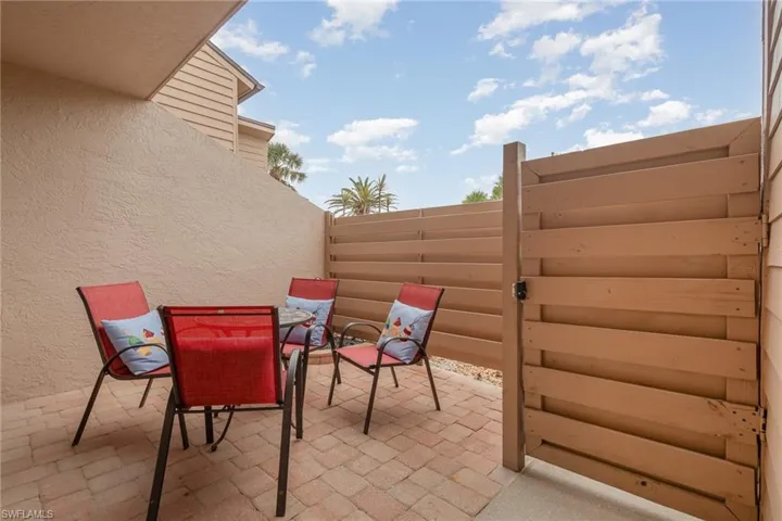 View of patio featuring fence and outdoor dining space