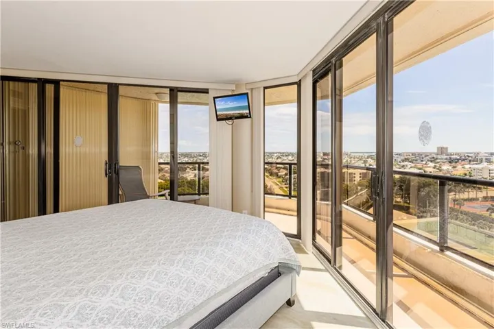 Bedroom with floor to ceiling windows and access to exterior
