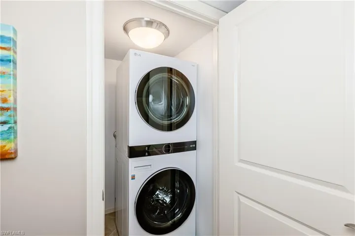 Laundry area with laundry area and stacked washer / drying machine