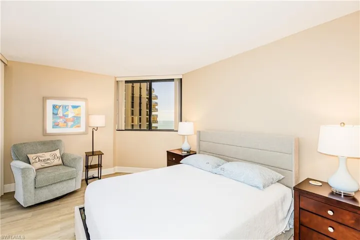 Bedroom with light wood finished floors and baseboards