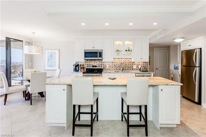 Kitchen featuring tasteful backsplash, visible vents, stainless steel appliances, and a sink