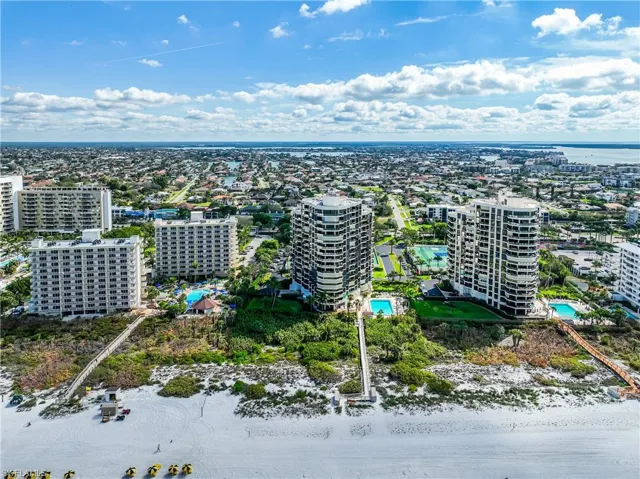 Birds eye view of property featuring a water view and a city view
