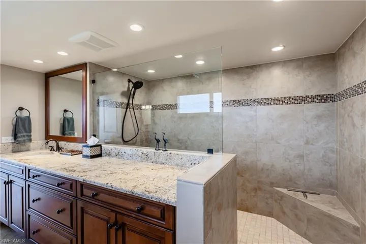 Full bathroom featuring a walk in shower, visible vents, vanity, and recessed lighting