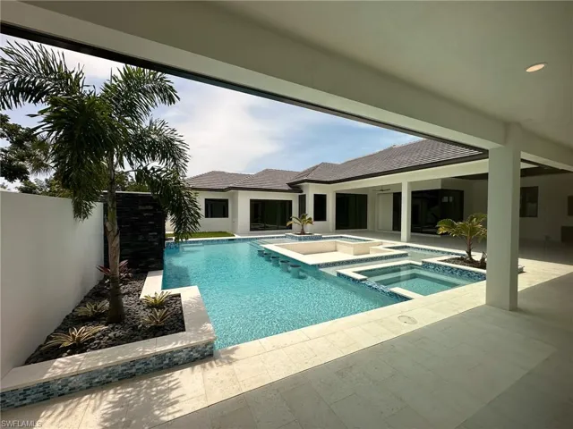 View of pool featuring an in ground hot tub and a patio