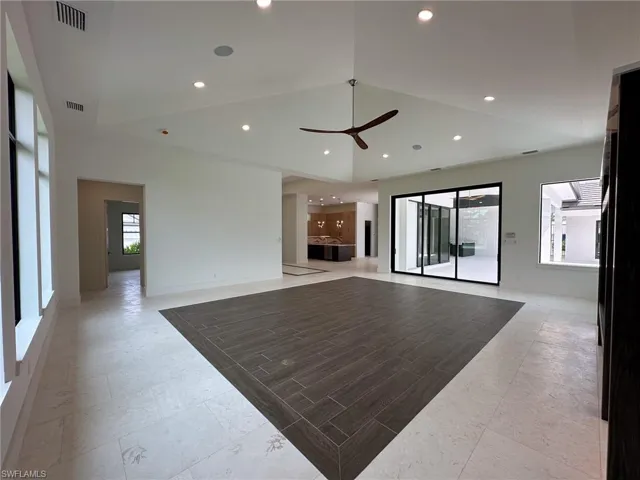 Living room with high vaulted ceiling, opens to Lanai Pool Lounge
