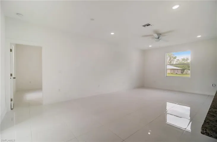 Spare room featuring light tile patterned flooring and ceiling fan