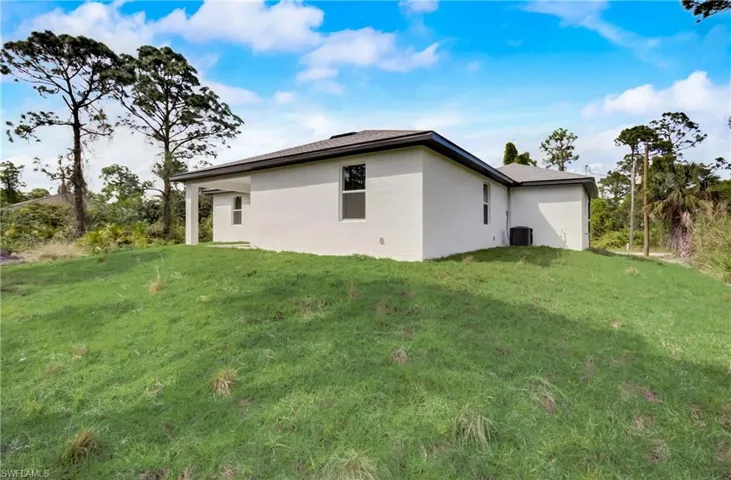 View of home's exterior with central air condition unit and a lawn