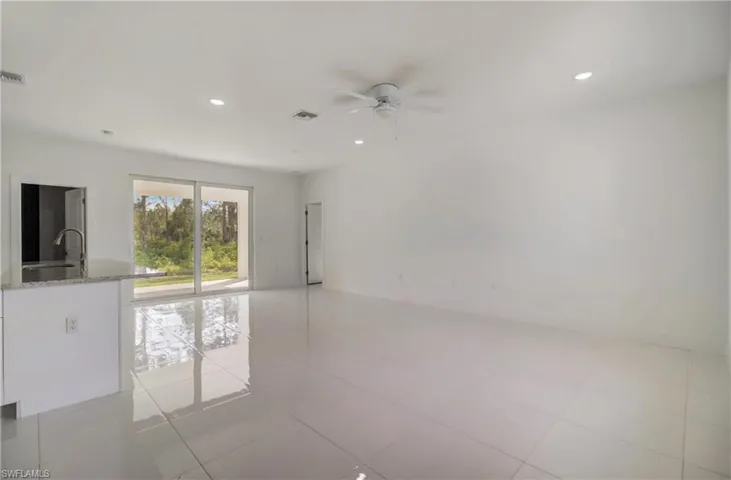 Empty room with sink, ceiling fan, and light tile patterned floors