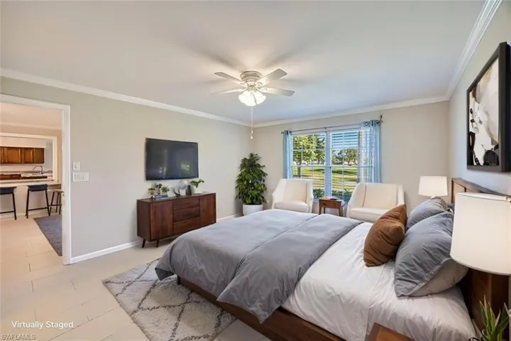 *VIRTUALLY STAGED*Bedroom featuring ornamental molding, a ceiling fan, and light tile patterned flooring