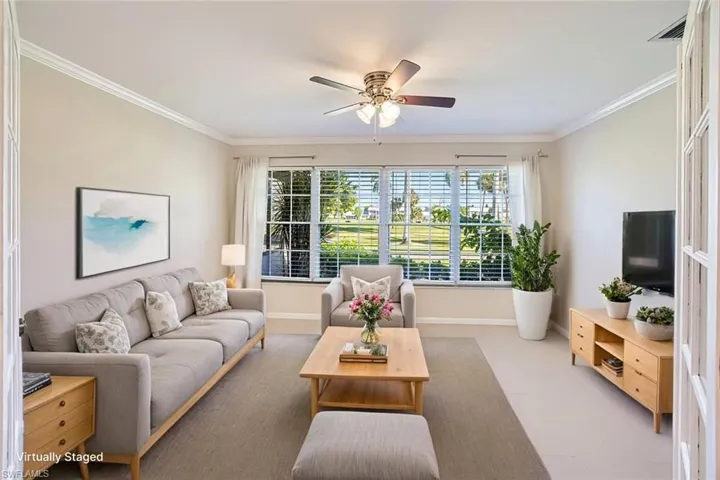 *VIRTUALLY STAGED*Spare room with ornamental molding, plenty of natural light, and ceiling fan