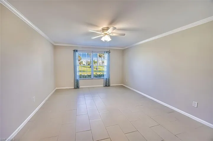 Spare room featuring ornamental molding and ceiling fan