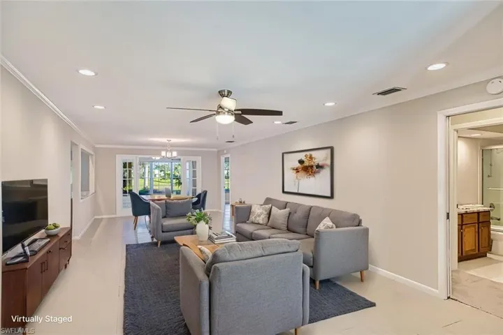 *VIRTUALLY STAGED*Living area with recessed lighting, ornamental molding, ceiling fan, and a chandelier
