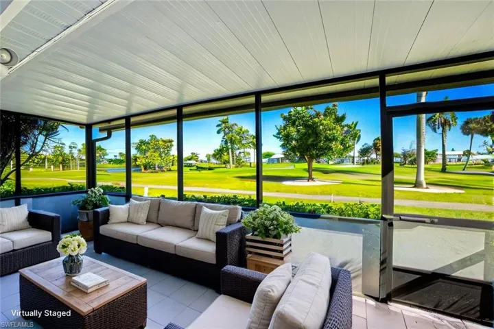 *VIRTUALLY STAGED*Sunroom / solarium with an outdoor living space and golf course view