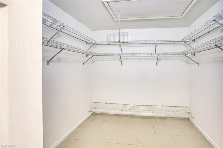 Spacious closet featuring attic access