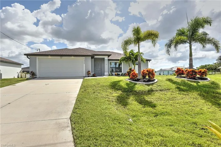 Ranch-style house with a garage and a front yard