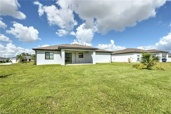 Rear view of property featuring a lawn