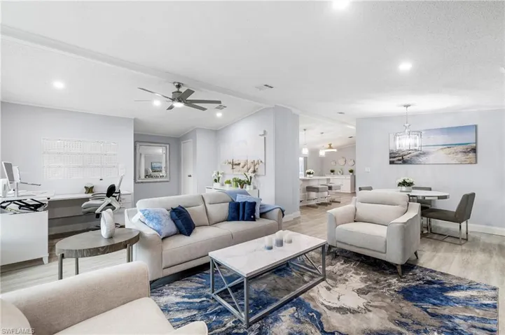 Living area with wood finished floors, a ceiling fan, and recessed lighting