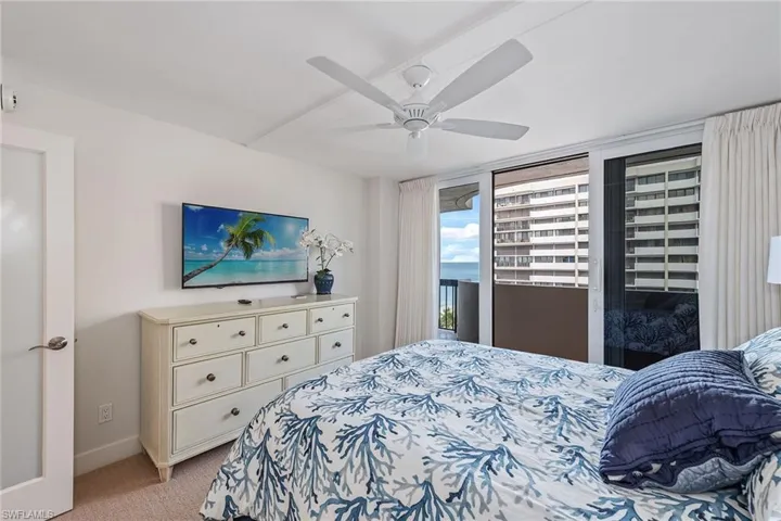 Bedroom featuring light carpet, access to outside, and ceiling fan