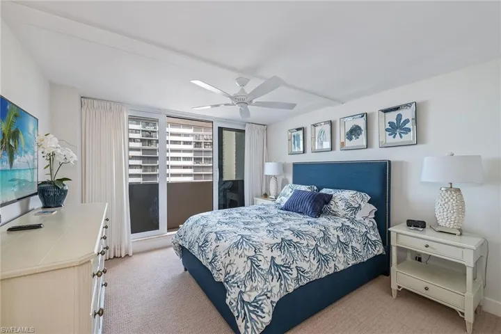 Bedroom featuring light colored carpet and ceiling fan