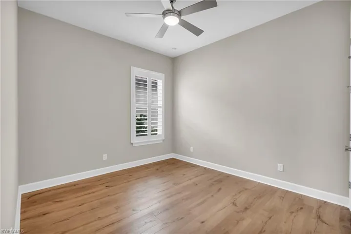 Spare room with ceiling fan and light hardwood / wood-style floors