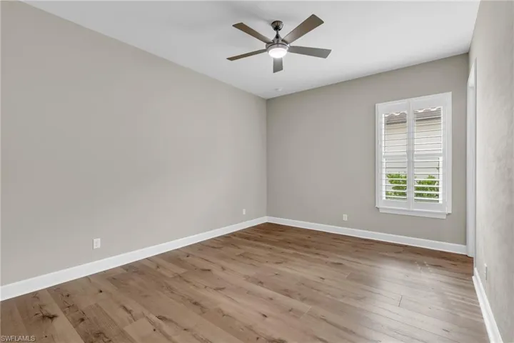 Unfurnished room featuring ceiling fan and light hardwood / wood-style floors