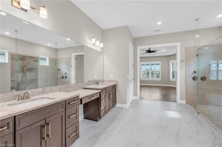 Bathroom with ceiling fan, vanity, hardwood / wood-style floors, and tiled shower