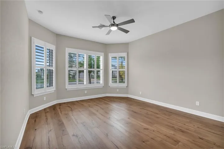 Unfurnished room with ceiling fan and light hardwood / wood-style flooring