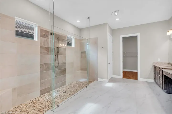 Bathroom with vanity and a tile shower