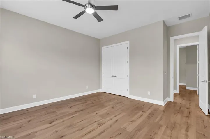 Unfurnished bedroom featuring ceiling fan and light wood-type flooring