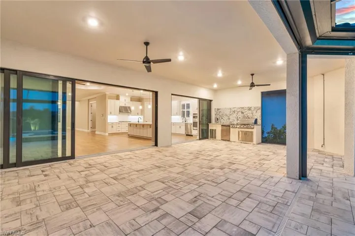 View of patio featuring ceiling fan and area for grilling