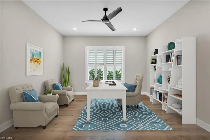 Office with ceiling fan and light hardwood / wood-style flooring
