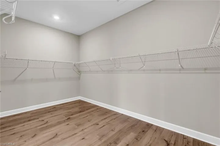 Walk in closet featuring hardwood / wood-style flooring