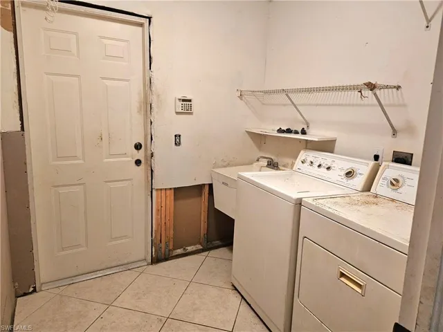 Laundry area featuring tiled floors & wash sink