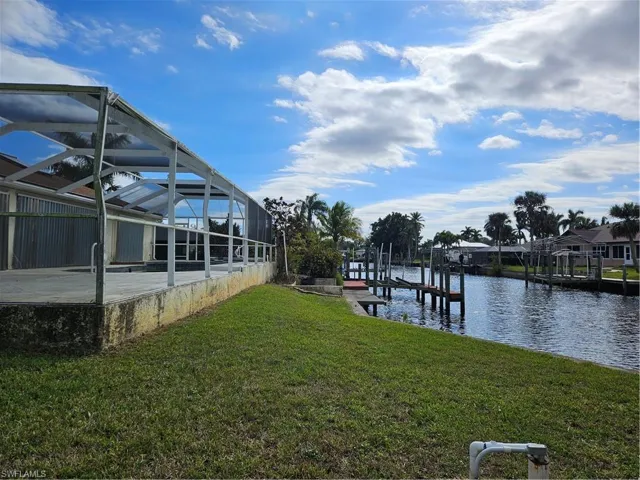 Captains walk dock boat lift, Gulf access canal, pool lanai rear yard view