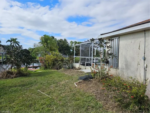left side of house with extended driveway