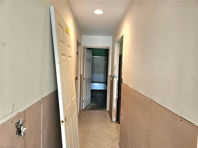 Hallway featuring light tile patterned floors