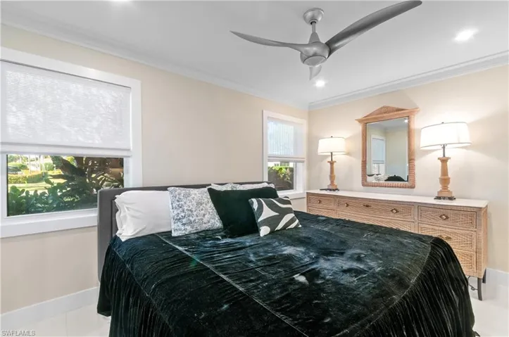 Bedroom featuring crown molding and a ceiling fan